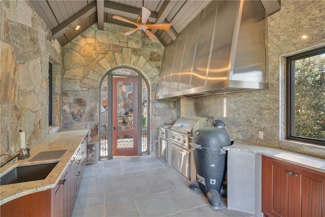 kitchen featuring decorative backsplash, wood ceiling, lofted ceiling with beams, wall chimney exhaust hood, and sink