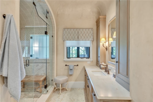 bathroom with vanity and a shower with door