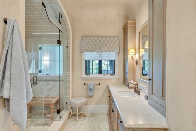 bathroom with vanity and a shower with door