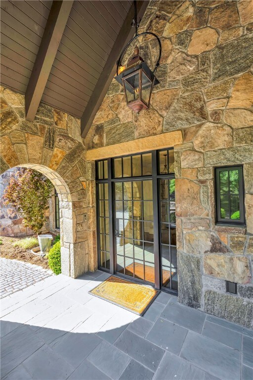 property entrance featuring a patio