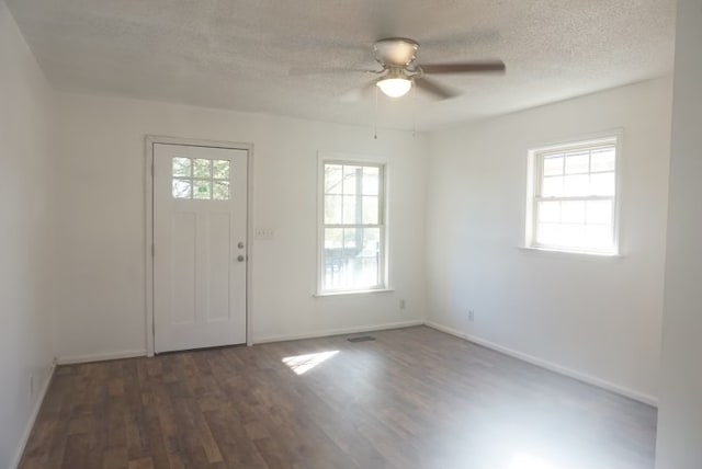 entrance foyer featuring dark hardwood / wood-style floors, ceiling fan, and a textured ceiling