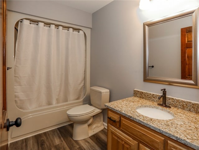 full bathroom with vanity, hardwood / wood-style flooring, toilet, and shower / tub combo with curtain