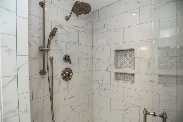 bathroom with a tile shower