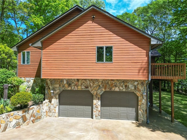 view of side of home with a garage and a wooden deck