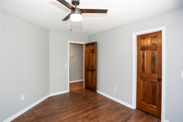 unfurnished bedroom with ceiling fan and dark hardwood / wood-style floors