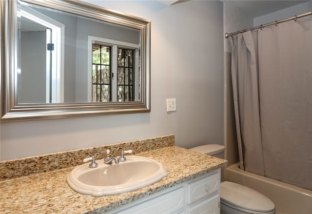 full bathroom with shower / bath combo, vanity, and toilet