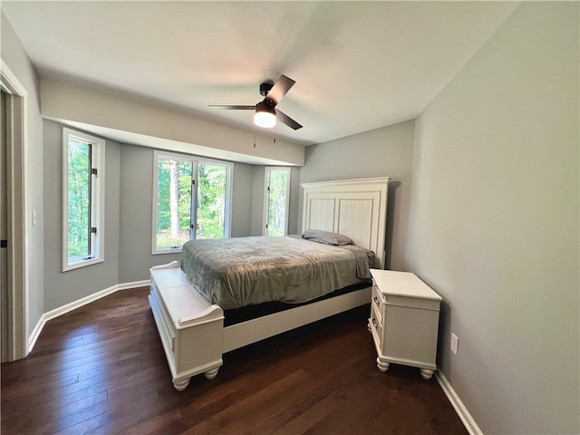 bedroom with ceiling fan and dark hardwood / wood-style floors