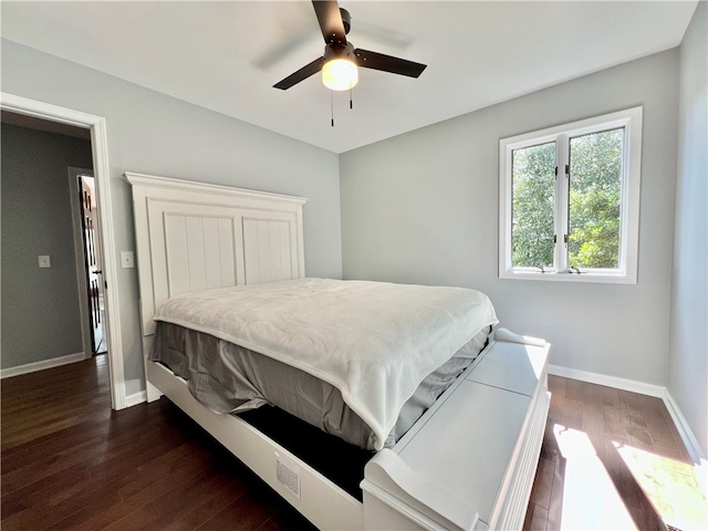 bedroom with dark hardwood / wood-style floors and ceiling fan