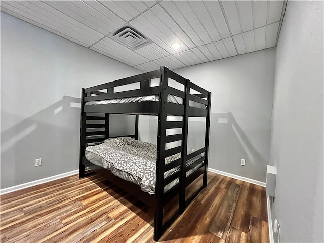 bedroom with dark hardwood / wood-style floors