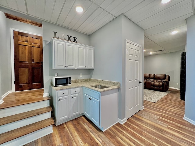 kitchen featuring light hardwood / wood-style floors and white cabinets