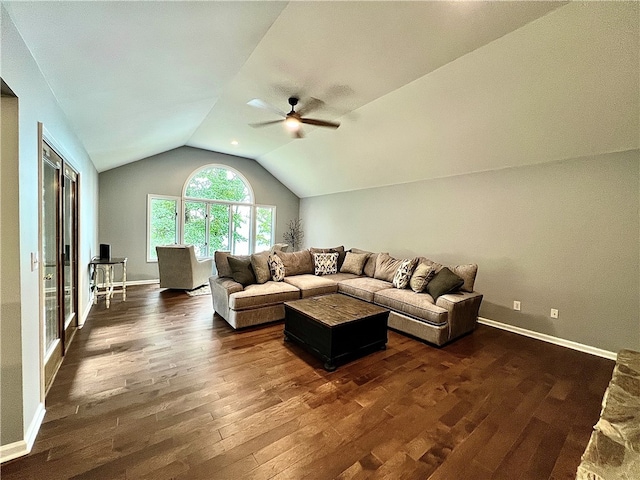 living room with lofted ceiling, ceiling fan, and dark wood-type flooring