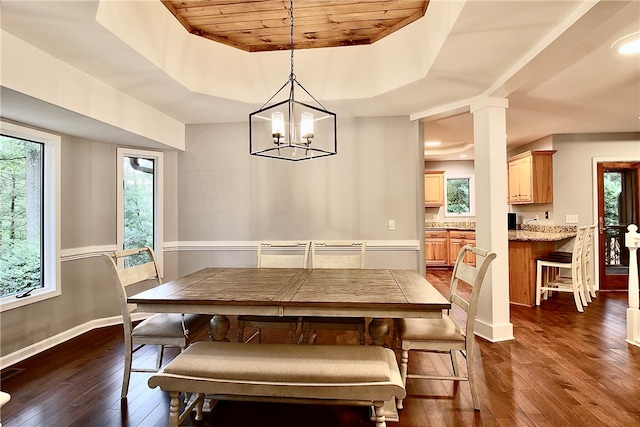 dining room with wood ceiling, a tray ceiling, dark hardwood / wood-style flooring, and a chandelier