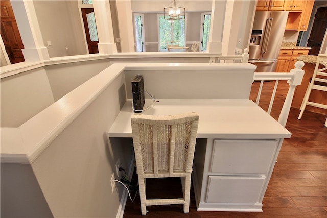 details featuring hardwood / wood-style flooring, an inviting chandelier, and high end fridge