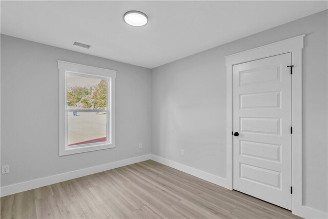 unfurnished room featuring light hardwood / wood-style floors