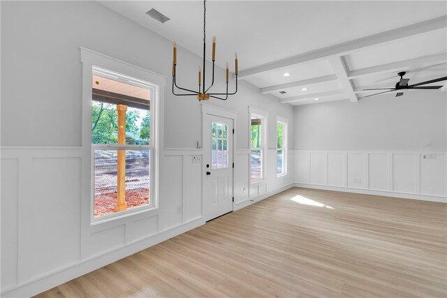 interior space featuring beamed ceiling, ceiling fan with notable chandelier, and light hardwood / wood-style floors