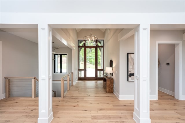 entryway featuring an inviting chandelier and light hardwood / wood-style flooring