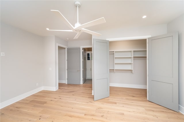 unfurnished bedroom featuring ceiling fan, a closet, and light hardwood / wood-style flooring