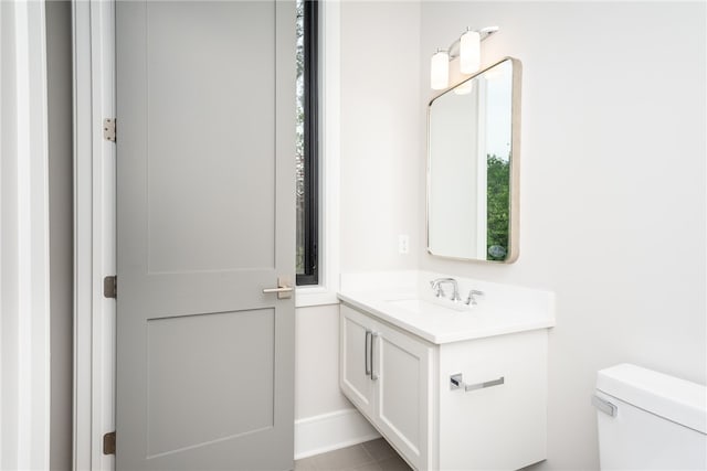 bathroom with tile patterned floors, vanity, and toilet