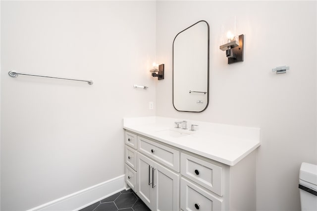 bathroom with tile patterned flooring, vanity, and toilet