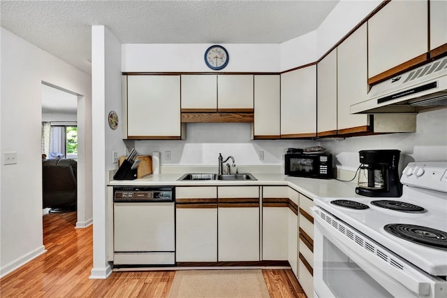 kitchen with white cabinetry, sink, white appliances, and ventilation hood