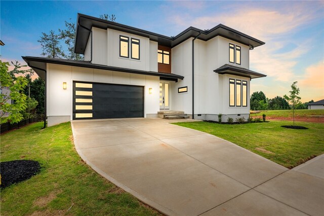 view of front of property featuring a yard and a garage