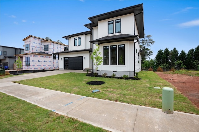 view of front of property with a garage and a front yard