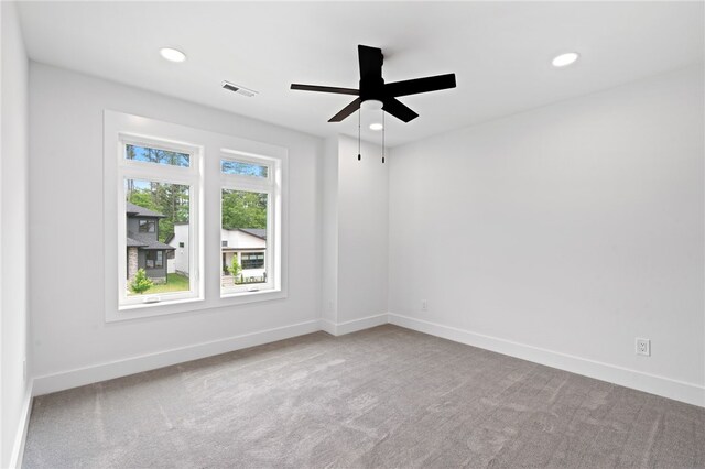 carpeted empty room featuring ceiling fan