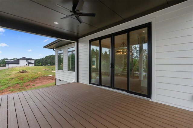 wooden deck featuring ceiling fan