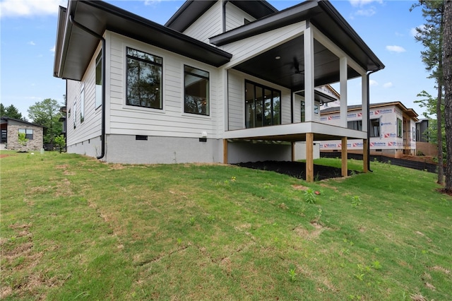 rear view of house featuring a yard