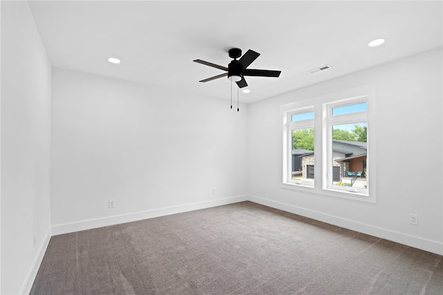 empty room with ceiling fan and carpet