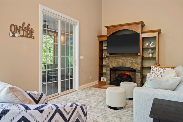 living room with wood-type flooring and a fireplace