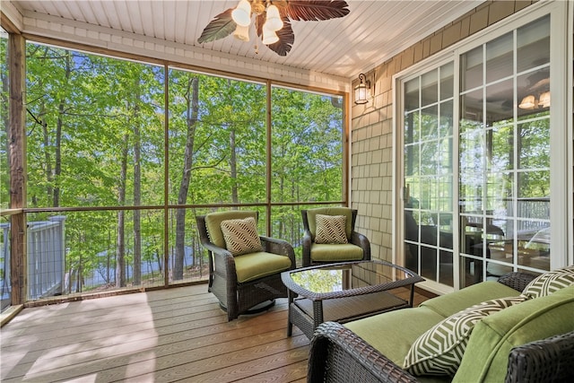 sunroom with wood ceiling, a wealth of natural light, and ceiling fan