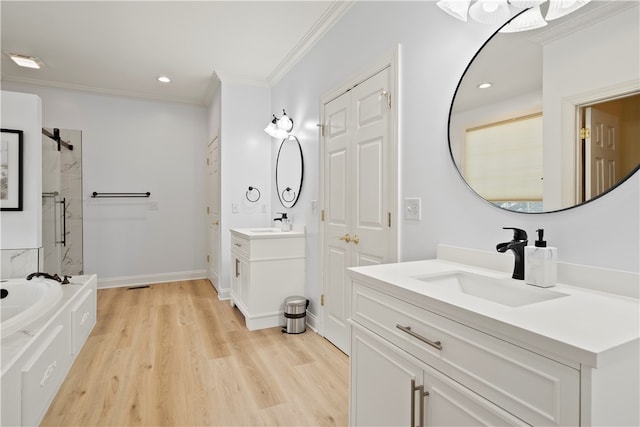 bathroom with independent shower and bath, vanity, ornamental molding, and hardwood / wood-style flooring