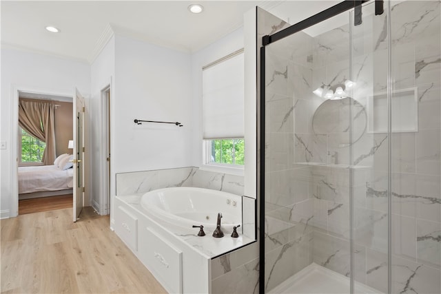 bathroom with shower with separate bathtub, crown molding, hardwood / wood-style floors, and a wealth of natural light