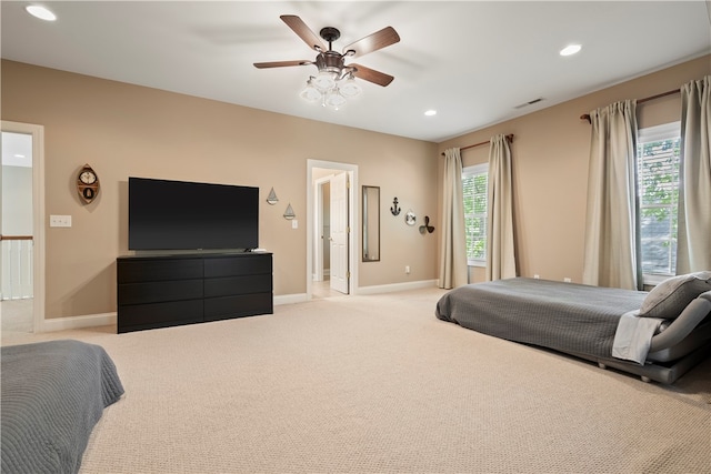 bedroom featuring ceiling fan and light carpet