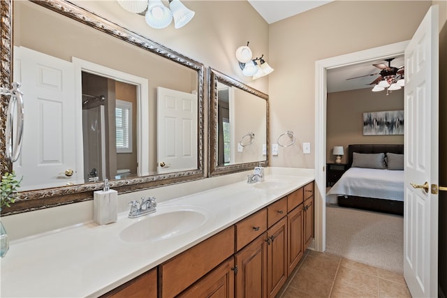 bathroom with ceiling fan, vanity, toilet, a shower, and tile patterned flooring