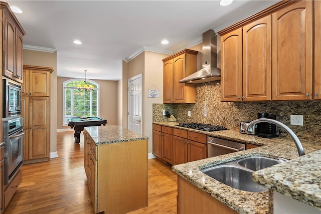 kitchen with pool table, light wood-type flooring, wall chimney range hood, and light stone counters