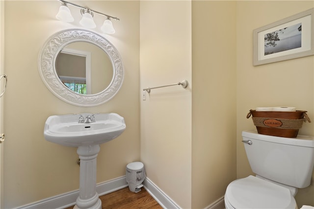 bathroom featuring hardwood / wood-style flooring and toilet