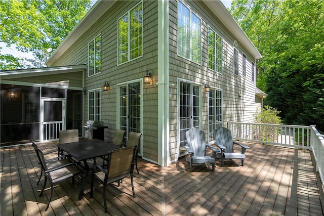 wooden deck featuring a grill