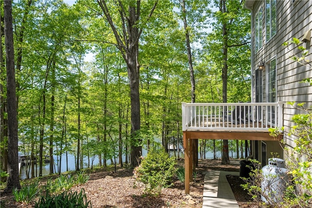 view of yard featuring a deck with water view