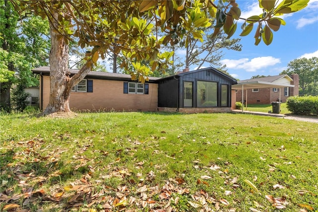 rear view of property with a yard