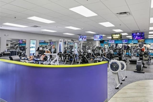 exercise room with a paneled ceiling