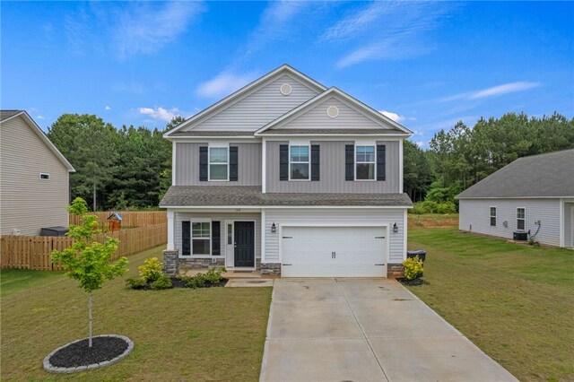 view of front of house with a garage, central air condition unit, and a front yard