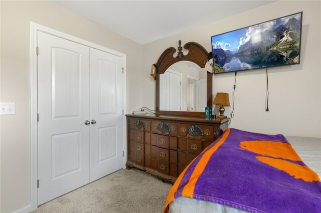 carpeted bedroom featuring a closet