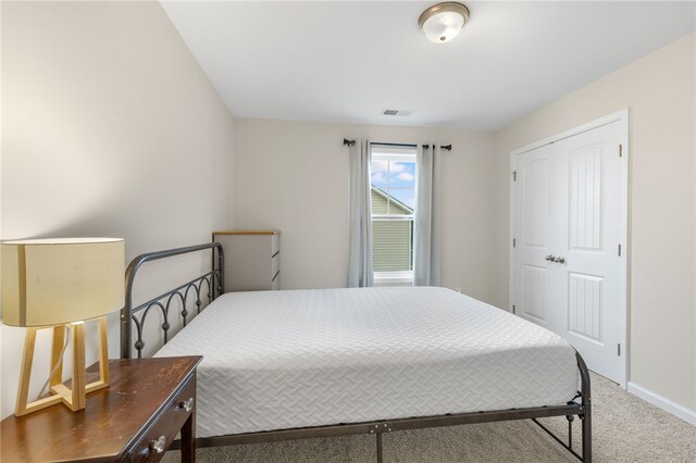 carpeted bedroom with a closet