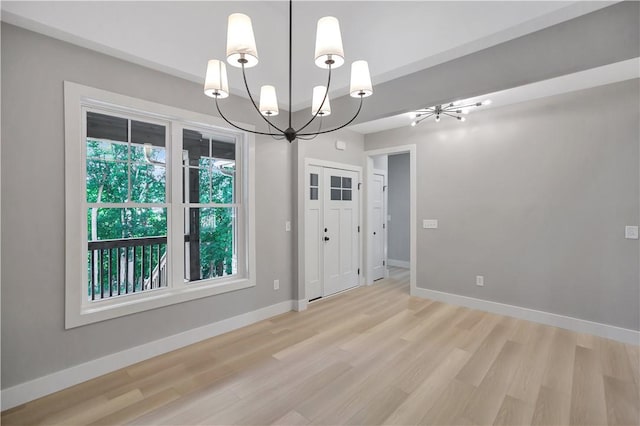 interior space featuring light hardwood / wood-style floors and an inviting chandelier