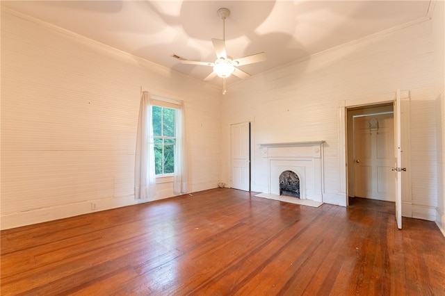 unfurnished living room featuring ornamental molding, ceiling fan, and dark hardwood / wood-style floors