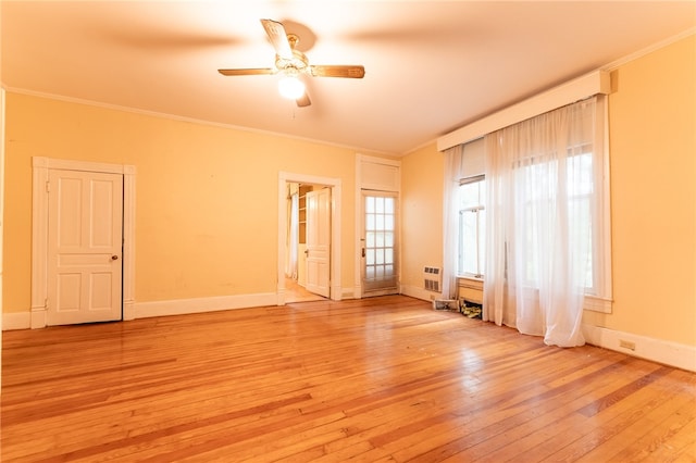 empty room with crown molding, light hardwood / wood-style floors, and ceiling fan