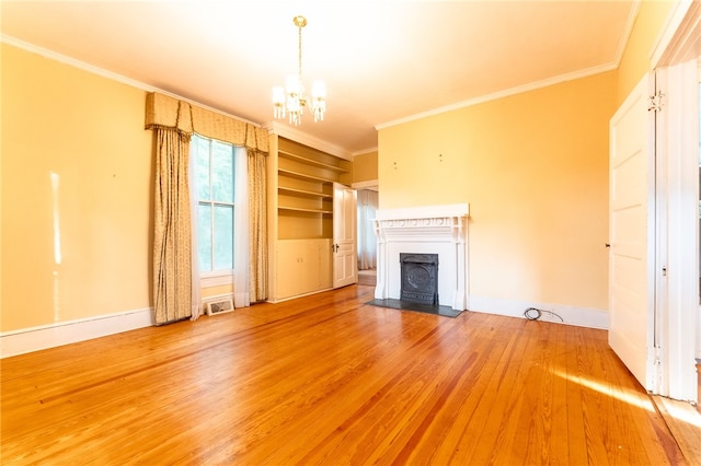 unfurnished living room featuring an inviting chandelier, wood-type flooring, and crown molding