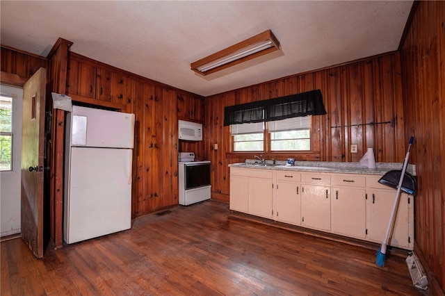 kitchen featuring white cabinets, dark wood-type flooring, white appliances, and a healthy amount of sunlight